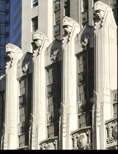 an old building with statues on the front and side of it in black and white