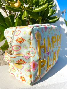 the cutest nylon Happy Place bag to keep all your accessories dry while having fun in the sun! This print is perfect for summer + a green stripe interior! Patches are yellow + sewn on, ships immediately! Pair it with our Vacay L or Beach Clear pouch bag for a set! Beautiful artwork in collaboration with Fete Papier! Dimensions: 26*8.5*14cm Summer Vacation Bags With Zipper Pouch, Summer Vacation Bag With Zipper Pouch, Playful Green Bags For Vacation, Playful Green Vacation Bags, Green Zipper Pouch Bag For Summer, Playful Travel Bags For Beach Season, Fun Green Bags For Vacation, Fun Yellow Summer Bag, Fun Yellow Summer Bags