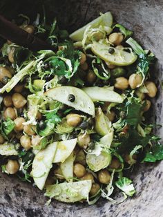 a close up of a bowl of food with broccoli and chickpeas