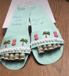 an open pair of flip flops decorated with money and palm trees on the inside