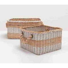 two wicker baskets with rope handles on white background