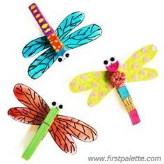 three dragonflys made out of construction paper