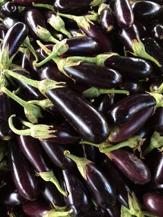 many eggplant are gathered together on the table to be used as garnishes