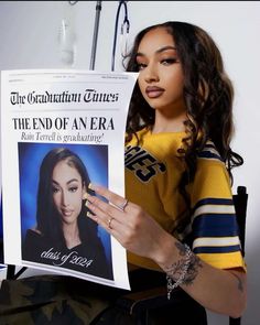 a woman holding up a newspaper with an image of her on it