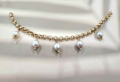 This bracelet features beautiful white freshwater  pearls. Pearls add a touch of sophistication  to this playful bracelet. We have 5 pearls all caped in 14k gold dangling from  6.5 inches of large rolo link chain  with a lobster clasp enclosure.  Stamped 14k on the clap. 7.81 grams total  This bracelet comes carefully wrapped and shipped in a Fedex package including insurance. Fedex Package, Diamond Heart Ring, Hippie Bracelets, Vintage Pearl, White Freshwater Pearl, Diamond Rings Bands, Domed Ring, Vintage Pearls, Diamond Heart