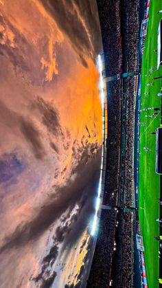 an aerial view of a soccer stadium with the sky in the background