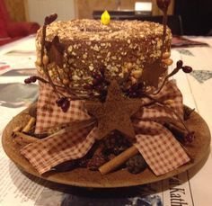 there is a cake that has been decorated with nuts and cinnamons on top of it