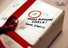 a birthday card wrapped in white paper with a red ribbon around it and the words happy birthday carla love claire