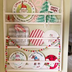 a white shelf filled with christmas plates on top of a wall