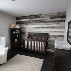 a baby's room is decorated with wood planks