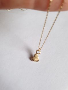 Solid gold necklace, heart necklace, 14k gold necklace, gold pendant necklace, 9k necklace, minimalist necklace, Bat Mitzvah gift This solid gold heart necklace has a beautiful tiny heart pendant, which is attached to a delicate 14k solid gold necklace. The small heart pendant is chicly hung sideways. The heart gold pendant is available both in 9k and 14 karat solid gold and is simply a great valentine's day gift or a perfect Bat mitzvah gift. Dimensions: The necklace is available in multiple le 14k Gold Heart Charm Necklace For Her, Minimalist 14k Gold-filled Necklace With Heart Charm, 14k Gold Heart Charm Necklace As Gift For Her, Minimalist 14k Gold Filled Necklaces With Heart Charm, Minimalist 14k Gold Filled Necklace With Heart Charm, Delicate 14k Yellow Gold Heart Necklace, Everyday 14k Yellow Gold Filled Heart Necklace, 14k Gold Charm Necklace With Heart Pendant, 14k Gold-filled Yellow Gold Heart Pendant Necklace