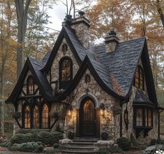 a stone and black house in the woods