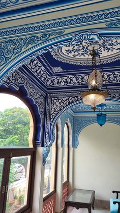 an ornate blue and white room with arched windows