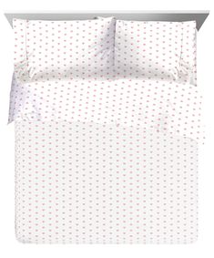 a white and red bed with hearts on the sheet set is shown in front of a white background