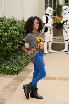 a young woman poses in front of star wars stormtroopers at disney world