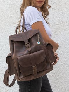 "Introducing our exquisite, extra large waxed brown leather backpack on Etsy! Crafted from premium full grain leather, this spacious bag features three pockets and a roomy interior. Complete with a captivating evil eye key ring, it's both stylish and functional. Embrace the perfect blend of durability and elegance with our backpack, exclusively available at Christina Christi Collection. Don't miss out on this unique accessory! 👉My Leather Backpacks Collection: https://etsy.me/2Lsw9yb YOU CAN BU Handmade Leather Backpack, Brown Backpacks, Women's Backpack, Brown Leather Backpack, Leather Rucksack, College Bags, Women Leather Backpack, Backpack Women, Backpack Travel