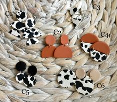 several different types of cow print buttons on a woven basket with numbers in the middle