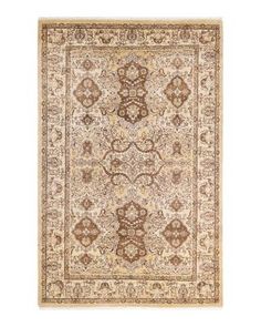 a beige and brown rug with an intricate design on the bottom, in front of a white background