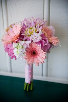 pink and white flowers are in a vase