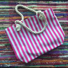 Pink And White Striped Beach Bag With Rope Handles. Waterproof Interior Ideal For A Beach Day. Zipper Pocket In The Interior Casual Pink Beach Bag For The Weekend, Casual Pink Beach Bag For Weekend, Trendy White Beach Bag For Vacation, Summer Weekend White Beach Bag, White Shoulder Bag With Adjustable Strap For Weekend, White Beach Bag For Vacation Weekend, Trendy White Shoulder Bag For Vacation, White Bag For Weekend Vacation, White Summer Beach Bag For Weekend