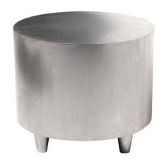 a round metal table sitting on top of a white floor