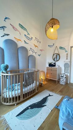 a baby's room with fish decals on the wall, and a crib