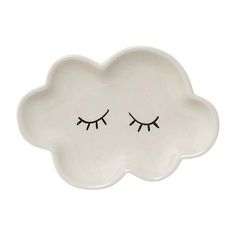 a white cloud shaped plate with eyelashes on it