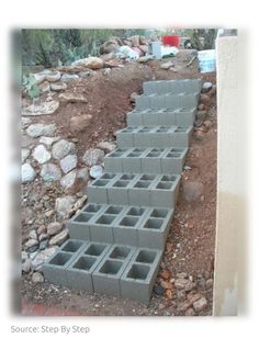 several cinder blocks stacked on top of each other in front of a pile of rocks