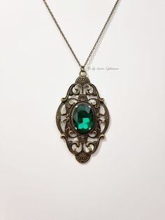 ◆ Emerald green crystal gothic necklace  The crystal measures 0,984252 x 0,708661 inches and is very bright, while the base measures 1,9685 x 3,14961 inches the jewel is embellished with a cameo with Victorian decorations. All necklaces in my shop are adjustable in length, but if you have demanding details you can safely contact me! ❤ The product is handmade with great care. ♡ In my shop there are many handmade jewelry for sale for all tastes, come and look at them you are welcome! ♡ ❤ Do you ne Antique Green Locket Jewelry, Green Vintage Charm Brass Jewelry, Ornate Green Jewelry With Jewels, Green Brass Jewelry With Vintage Charm, Formal Green Locket Necklace, Victorian Green Jewelry With Jewels, Victorian Green Jeweled Jewelry, Vintage Emerald Jewelry With Intricate Design, Antique Green Jewelry With Vintage Charm