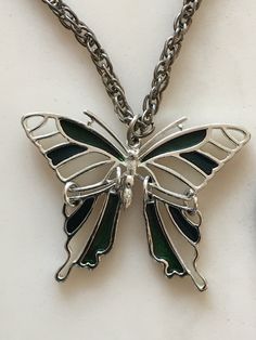 This beautiful antique butterfly pendant necklace is in excellent condition. This piece of jewelry would be a great addition to anyone's collection or as a gift. Elegant Silver Metal Butterfly Necklace, Vintage Silver Stainless Steel Necklaces, Vintage Silver Stainless Steel Necklace, Silver Metal Butterfly Necklace, Elegant Metal Butterfly Pendant Necklace, Metal Butterfly Clavicle Chain Jewelry, Butterfly Shaped Clavicle Chain Jewelry, Metal Butterfly Pendant Necklace With Clavicle Chain, Silver Butterfly Necklace With Clavicle Chain