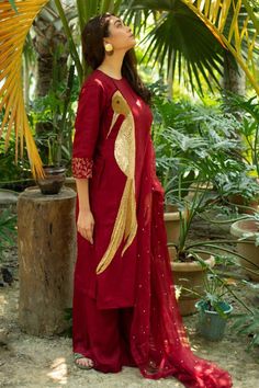 Maroon paneled A-Line kurta with hand embroidery. Comes with palazzo and a dupatta.
Component: 3
Pattern: Hand embroidered
Neckline: Round
Sleeve Type: Three quarter
Fabric: Dola silk, Organza
Color: Maroon
Other Details: 
Embroidered sleeves
Attached lining
Note : Outfit worn by the model on the right is not for sale.
Occasion: Mehendi and Haldi, Puja - Aza Fashions Semi-stitched Raw Silk Dresses, Raw Silk Dresses With Dupatta, Chanderi Dress With Mirror Work, Chanderi Dresses With Dupatta, Semi-stitched Cotton Silk Dresses, Cotton Silk Dress With Zari Work, Unstitched Cotton Silk Suit With Cutdana, Party Unstitched Suit With Cutdana, Slub Silk Dress With Dupatta