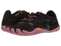 a pair of black and pink shoes with yellow laces on the outseats