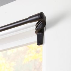 a close up of a curtain rod on a window