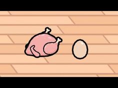 a chicken and an egg on a wooden floor