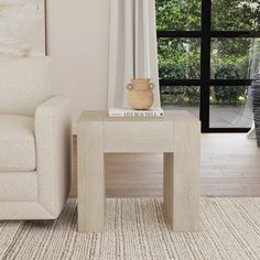 a living room with a couch, chair and coffee table in front of a window