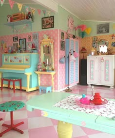 a brightly colored room with pink, blue and yellow furniture in it's center