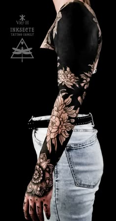 a woman with a tattoo on her arm and hand is standing in front of a black background