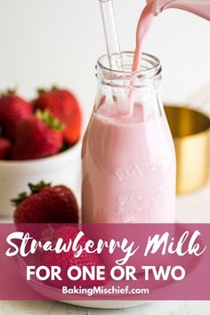 strawberry milk being poured into a glass jar