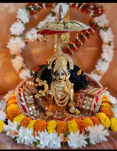 an idol is displayed in front of flowers