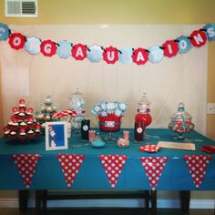 the table is set up with red, white and blue decorations for an american themed party