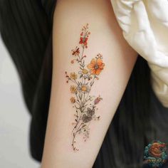 a woman's arm with flowers on it