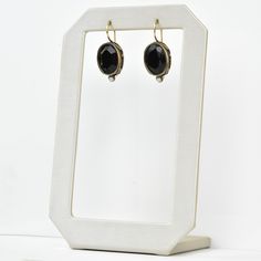 Faceted black glass stone Bronze components Pearl accents Locking french wire earring Earrings measure 1" long Made by Extasia Designer Jewelry. Goldmakers Jewelry Mission Statement Goldmakers Jewelry creates and curates a comprehensive selection of artfully designed hand-crafted jewelry. We aspire to offer the jewelry enthusiast access to affordable classics as well as fresh innovative designs. Black Drop Earrings With French Hook, Elegant Handmade Black Clip-on Earrings, Nickel-free Round Earrings For Evening, Elegant Brass Hoop Earrings With French Hook, Nickel Free Round Earrings For Evening, Elegant Adjustable Earrings With Lever Back Ear Wires, Onyx Earrings For Evening, Formal Metal Crystal Earrings With Ear Wire, Elegant Metal Hoop Earrings With French Hook