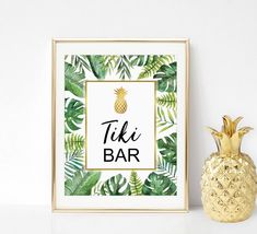 a gold pineapple next to a framed tiki bar sign