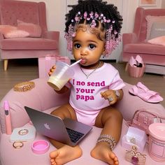 a baby doll sitting on a pink chair with a laptop and cup in her mouth