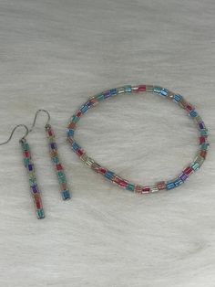 Hi Everyone,  Pick me, pick me. Handmade Earrings & Bracelet Set, Pink, Purple, Blue, Green, Orange Sqare Beads,  Silver Wire Earrings, Stretch Bracelet Handmade fashion jewelry accessories perfect simple gifts for her, perfect Mother's Day gifts too.  Can be for everyday look for women and her fashion accessory. The length is about 2 inches from top to bottom. The bracelet is 7.5 stretch, made with baritone color Sqare beads.  Thank you for looking at my jewelry shop. Multicolor Square Beaded Jewelry, Silver Wire Earrings, Pink Purple Blue, Blue Green Orange, Handmade Fashion Jewelry, Gorgeous Bracelet, Pretty Earrings, Wire Earrings, Fashion Accessories Jewelry