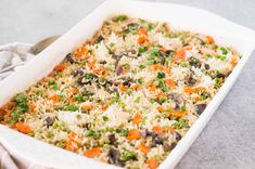 a casserole dish filled with rice and vegetables