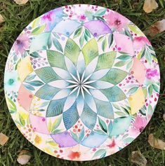 a painted plate sitting in the grass