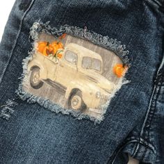 an old truck with pumpkins painted on it's back pocket is seen in this image