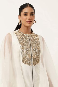 Ivory cape style kurta with gold floral embroidered yoke. Paired with matching pant. - Aza Fashions Festive White Kaftan With Gold Embroidery, Elegant White Kaftan With Gold Embroidery, Elegant Set With Cutdana And Cape Sleeves, Elegant Eid Cape Sets, Elegant Kaftan With Cutdana For Wedding, Elegant Cape Sets For Eid, Elegant Wedding Kaftan With Cutdana, Luxury White Festive Sets, Elegant Kaftan With Gold Embroidery