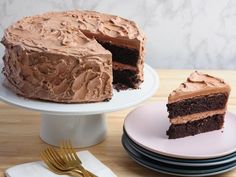 a chocolate cake with one slice cut out and the rest on plates next to it